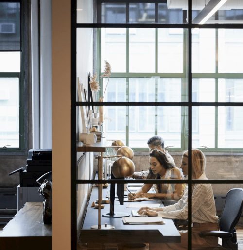 business-team-working-in-an-office-booth-vertical-PTNYV8Q-1920w business-team-working-in-an-office-booth-vertical-PTNYV8Q-1920w